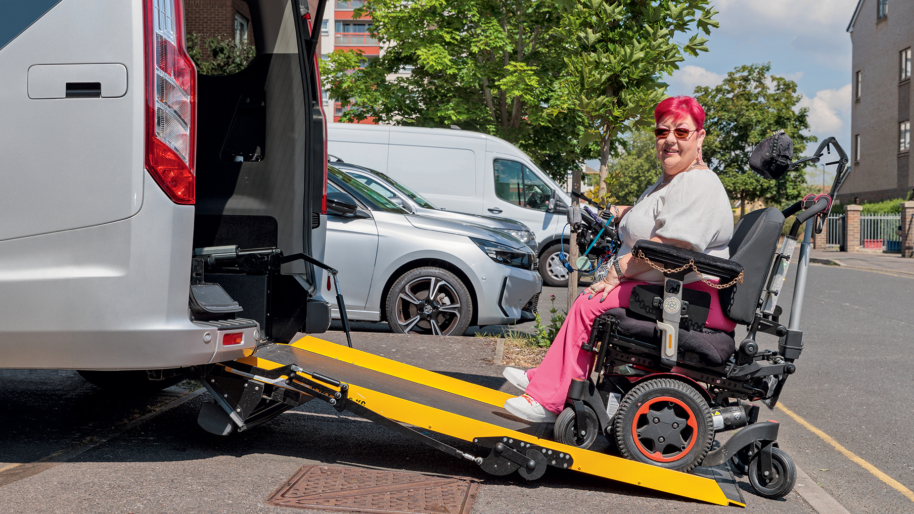 a-female-wheelchair-user-boarding-the-ramp-of-a-wheelchair-accessible-vehicle.jpg