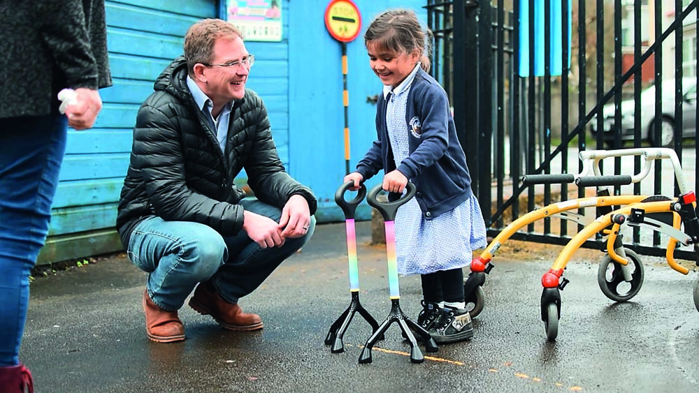 A man and a little girl with mobility aids