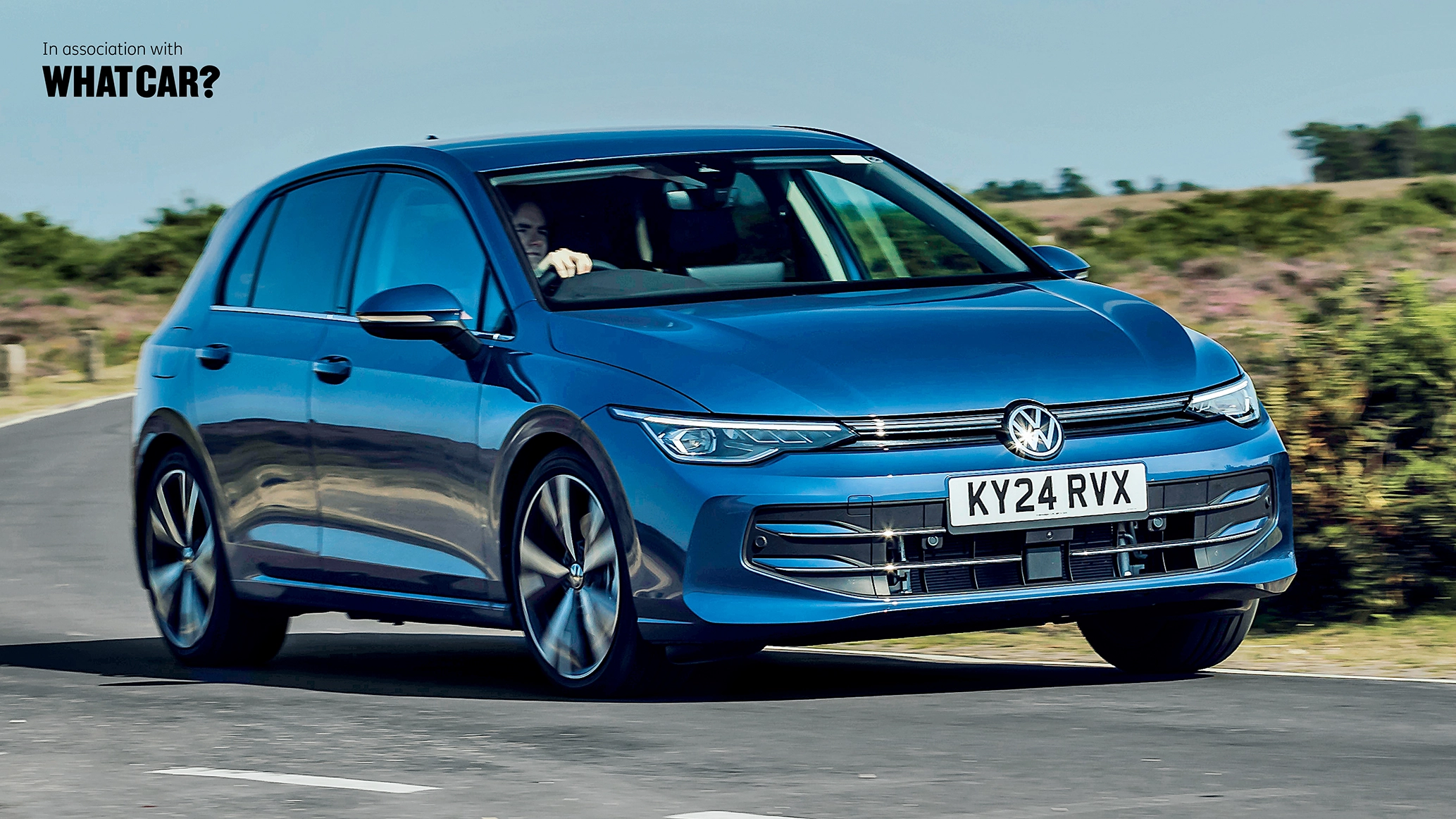 A VW Golf eHybrid being driven on a country road