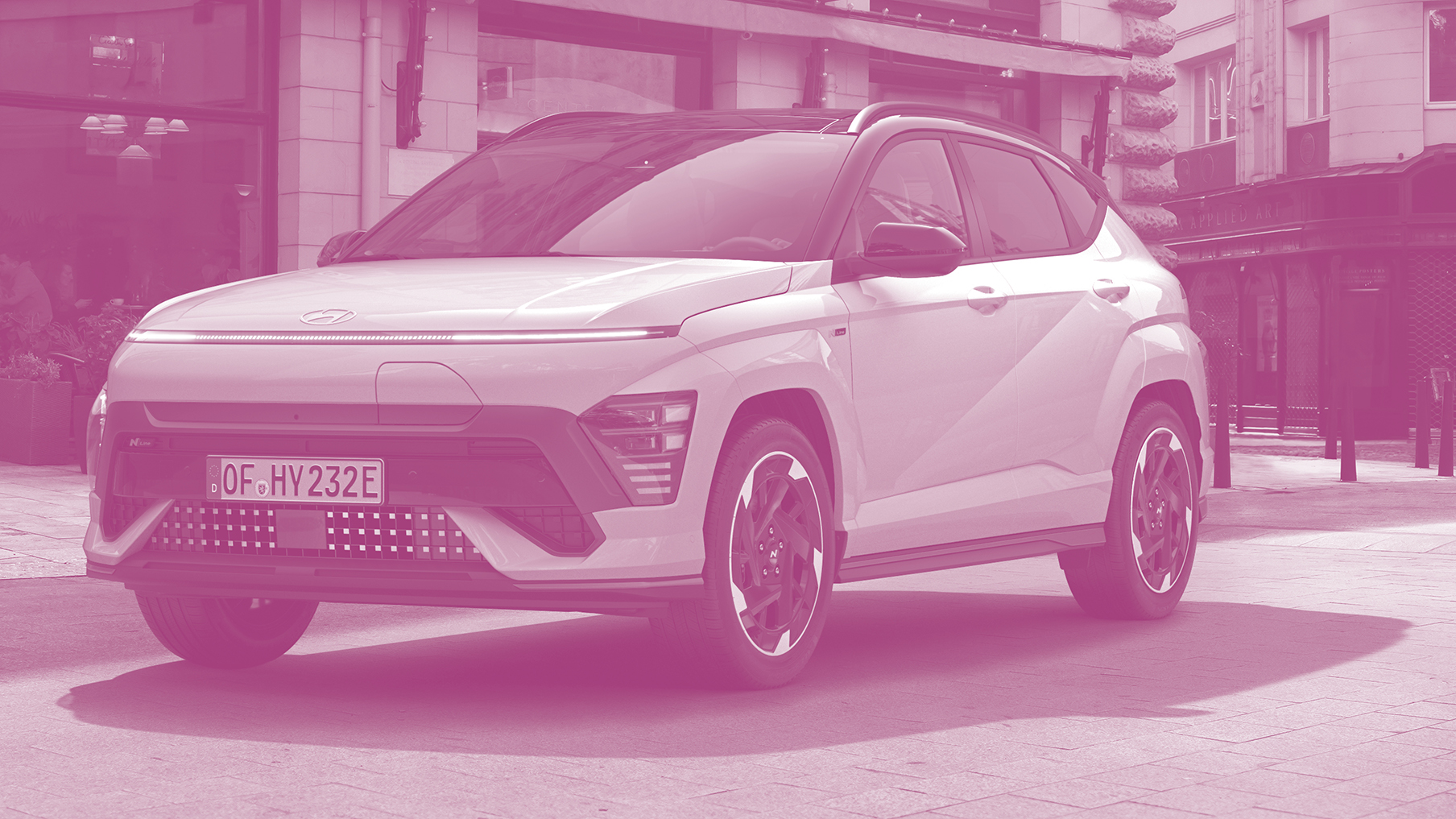 An image of a Hyundai Kona rendered in a urban landscape saturated in a pink hue