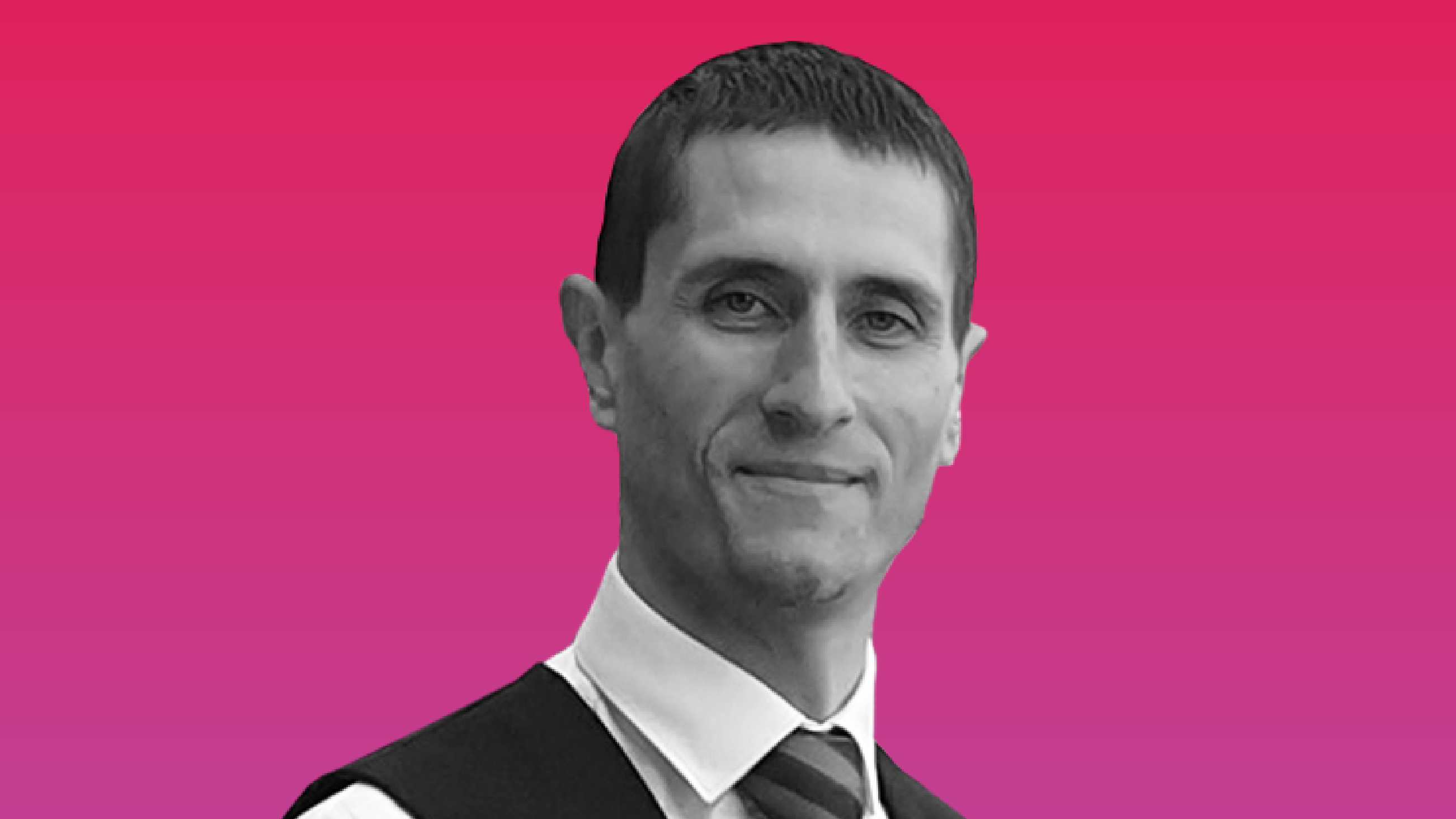 A portrait grayscale image over a pink background of Dominic Lund-Colon, Accessibility and Inclusion Manager at Rail Delivery Group