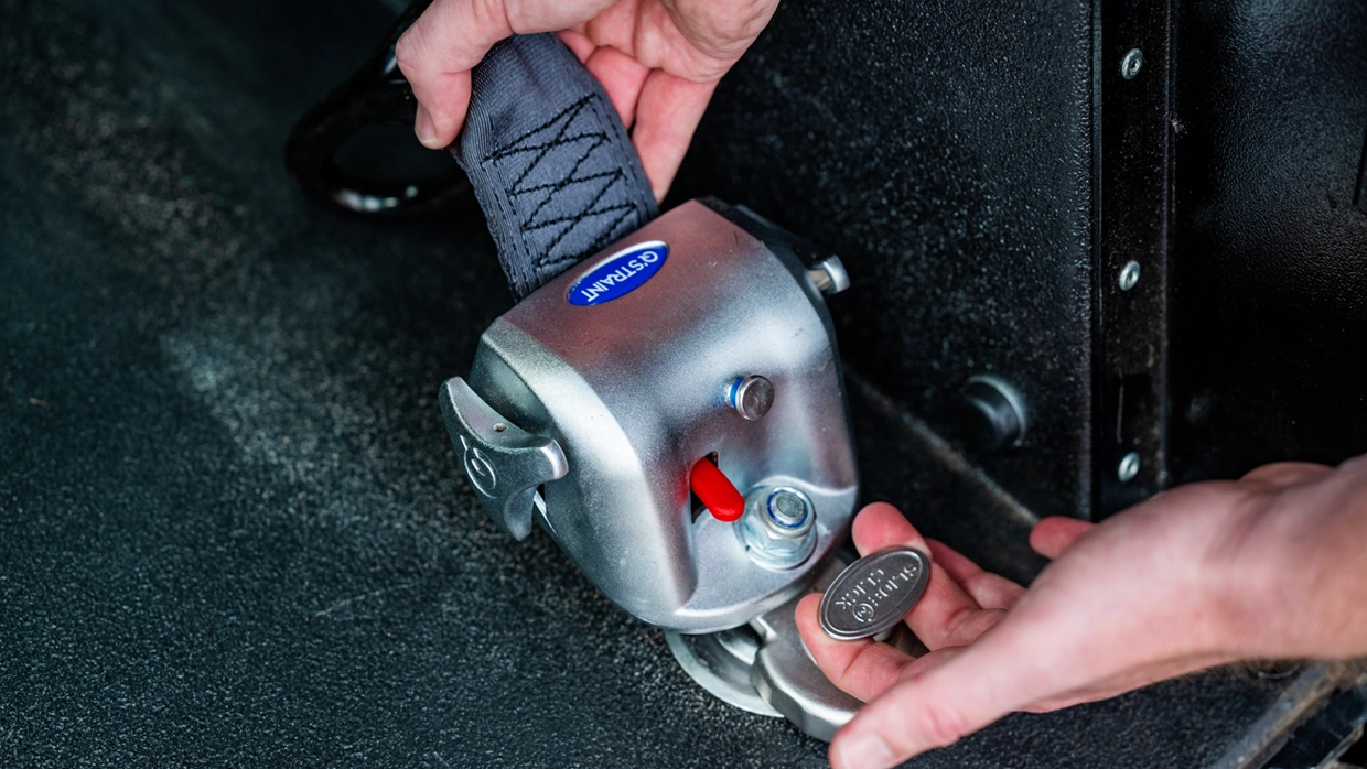 Close-up of a wheelchair clip-on attachment, used for securing inside a WAV