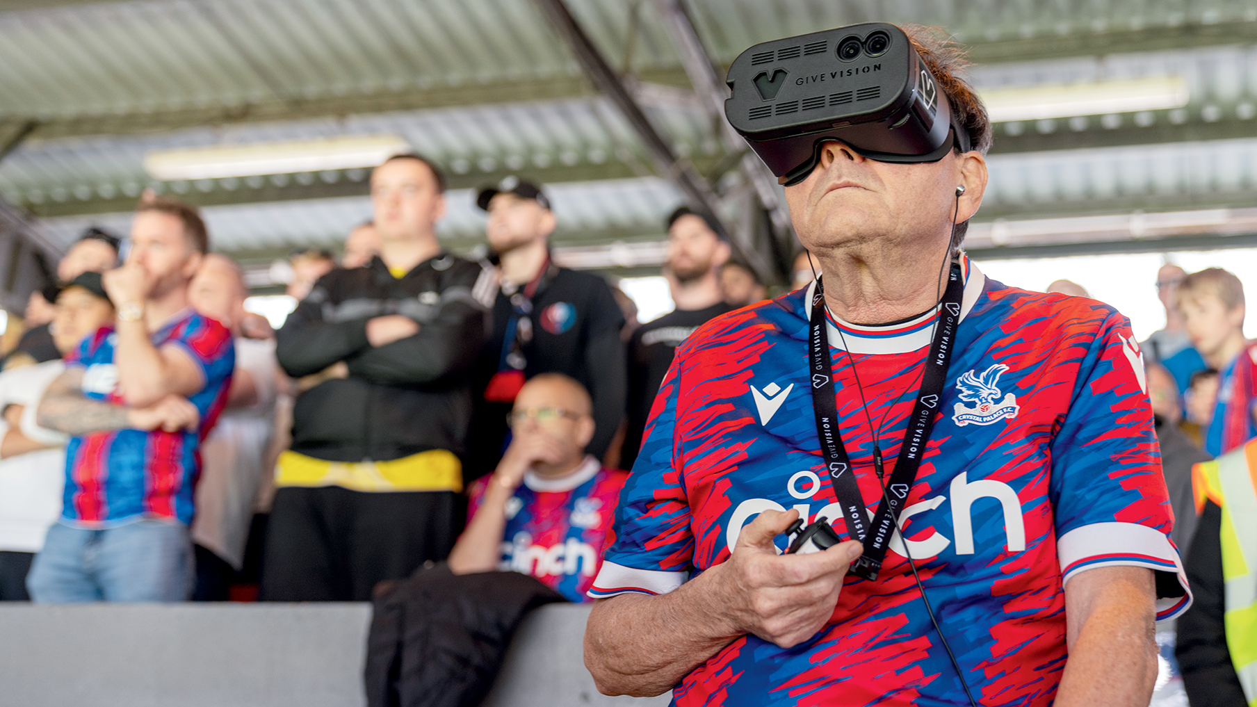 football fan wearing headset and looking out towards the ground