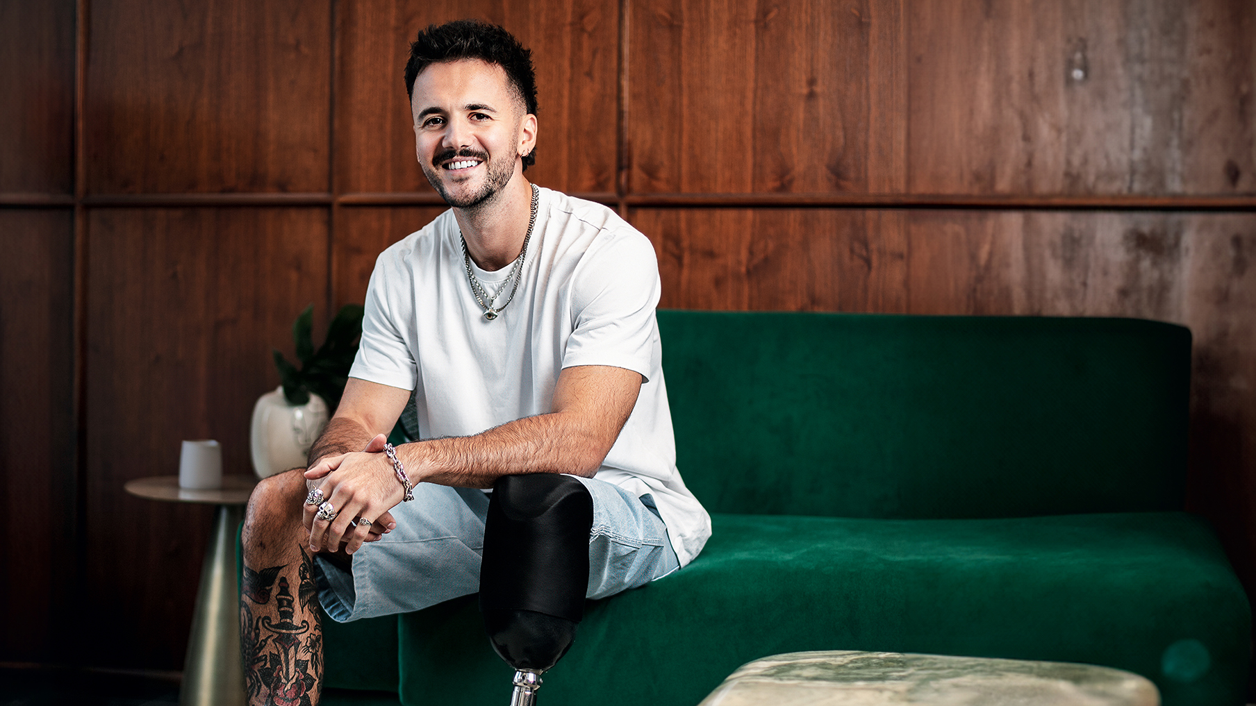 Luke Tarrant wearing a t-shirt and short smiling at the camera