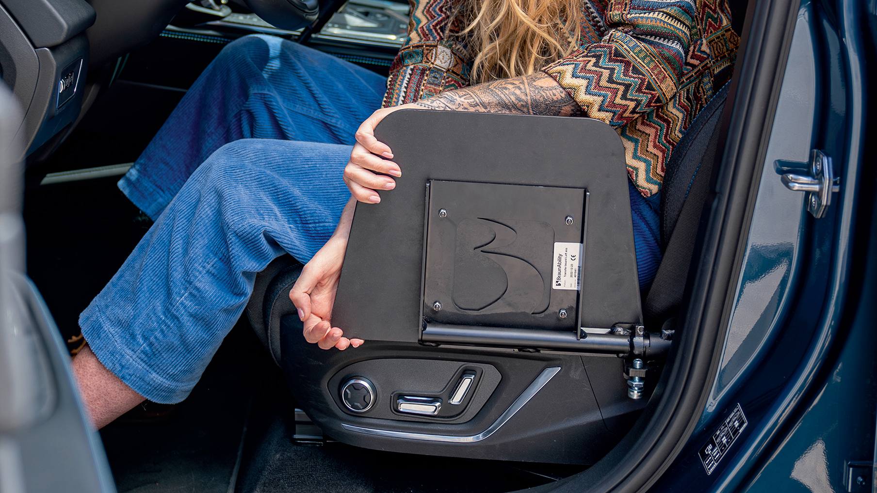 A car seat with adaptations for wheelchair users