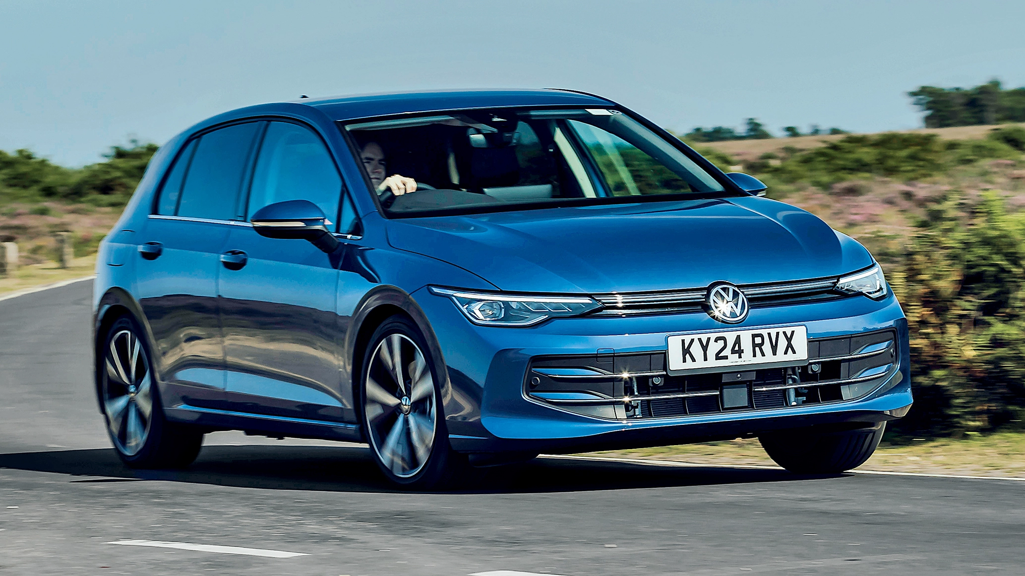 A VW Golf eHybrid being driven on a country road