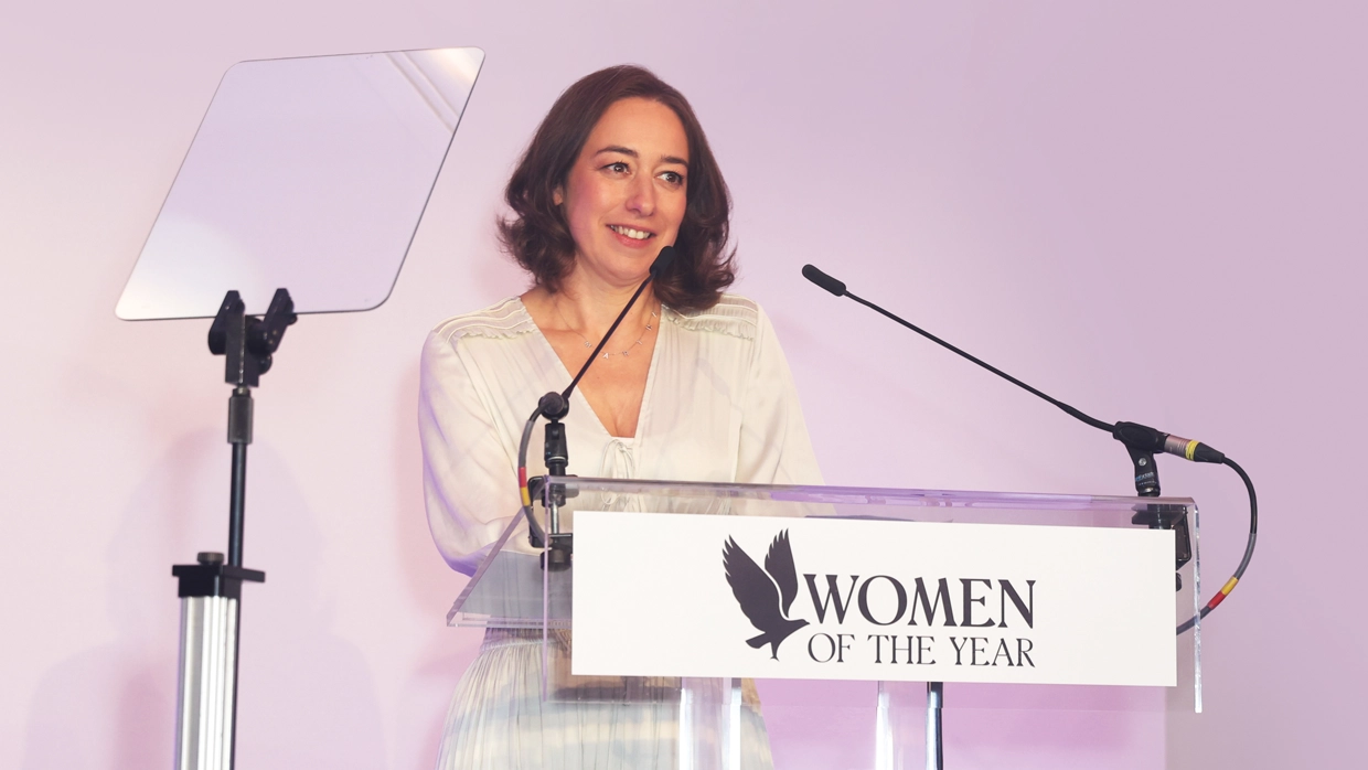 Martha's mother, Merope Mills in front of a mic